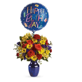 Birthday balloon above a colorful flower arrangement in a blue vase
