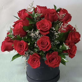 Bouquet of red roses in a black round box