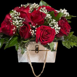 Red rose bouquet in a white handbag-shaped container