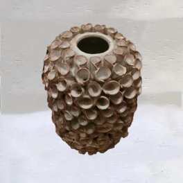 A textured brown ceramic vase with a round opening
