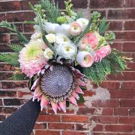 Hand-tied bouquet with pink and white flowers and a large thistle bloom