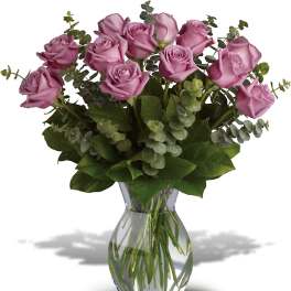 Pink roses arranged in a clear glass vase