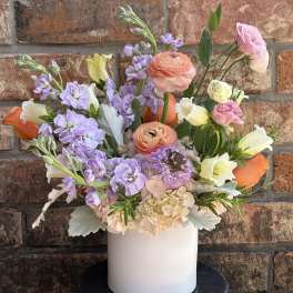 Pastel mixed bouquet in a white cylindrical vase