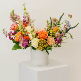 Colorful mixed bouquet in a white cylindrical vase