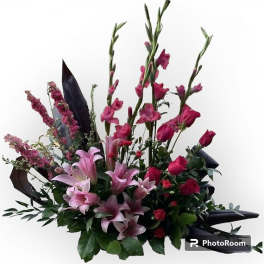 Pink lilies and roses in a tall mixed bouquet