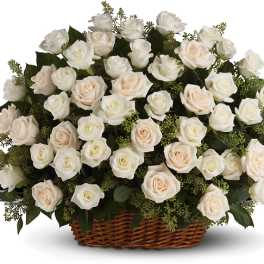 Basket of white and blush roses with greenery