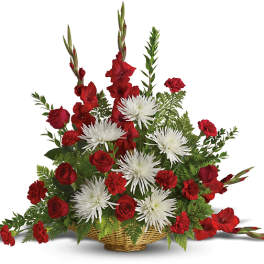 Red roses and white spider mums in a wicker basket