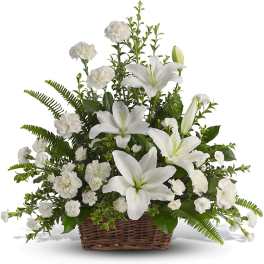 White lilies and carnations in a wicker basket