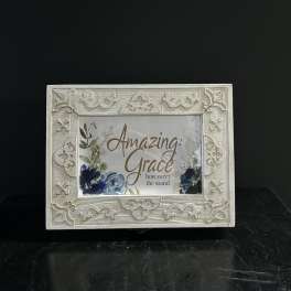 Decorative framed sign with floral artwork and the words Amazing Grace