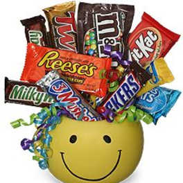 Smiley-face container filled with assorted candy bars and curly ribbon