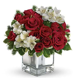 Red roses and white alstroemeria in a clear square vase