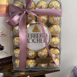 Box of Ferrero Rocher chocolates tied with a pink ribbon
