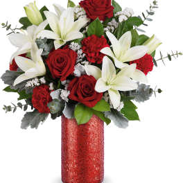 Red roses and white lilies in a red vase