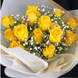 Bouquet of yellow roses with white baby's breath in paper wrap