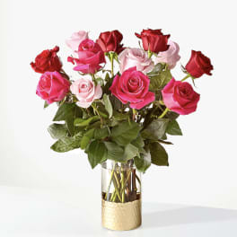 Bouquet of pink and red roses in a clear glass vase