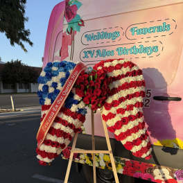 Large floral standing display in red, white, and blue on an easel
