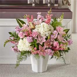Pink and white floral arrangement in a white vase