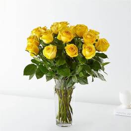 Bouquet of yellow roses in a clear glass vase