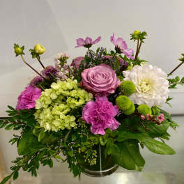 Compact vase arrangement with pink rose, white dahlia, green hydrangea and bright pink carnations