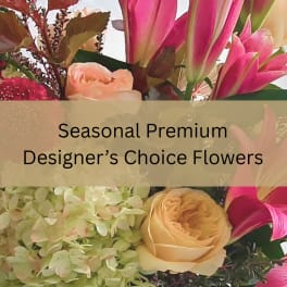 Pink lilies, peach roses and green hydrangeas with overlaid text reading Seasonal Premium Designer’s Choice Flowers.