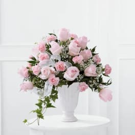 Pink rose and carnation bouquet in a white vase