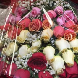 Bouquet of roses in red, pink, cream, and peach tones