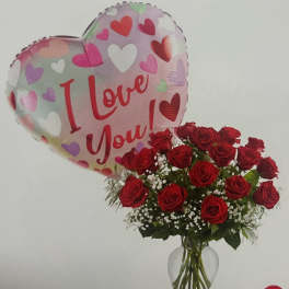 Red roses in a glass vase with a heart-shaped "I Love You" balloon