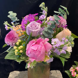 Pink and lavender bouquet in a ribbed glass vase