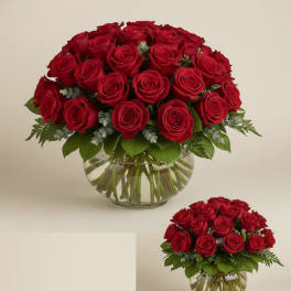 Red roses arranged in a clear glass vase