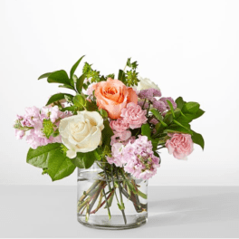 Bouquet of pink and white roses in a clear glass vase