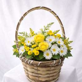 Yellow roses and white daisies in a wicker basket