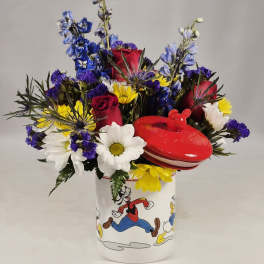 Mixed bouquet in a Disney-themed mug with a red lidded container
