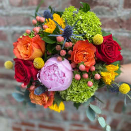Colorful bouquet of roses, peonies, and green hydrangeas