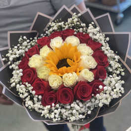 Bouquet of red and white roses with a sunflower center
