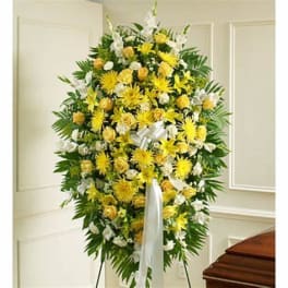 Standing floral spray of yellow and white flowers on an easel