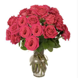 Bouquet of hot pink roses in a clear glass vase