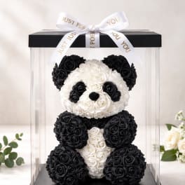 Black and white rose teddy bear in a clear gift box with a ribbon