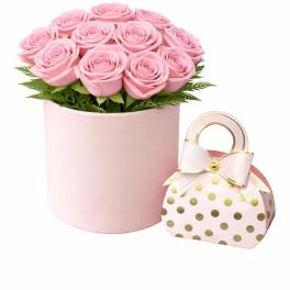 Pink rose arrangement in a round box with a polka-dot gift bag