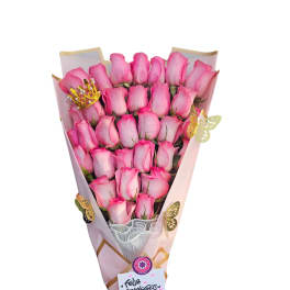 Bouquet of pink roses wrapped in pink paper with a ribbon