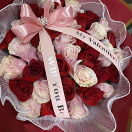 Bouquet of red and pale pink roses with a pink ribbon