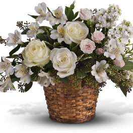 White roses and alstroemeria in a woven basket