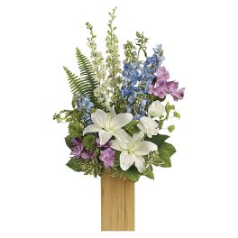 Tall floral arrangement with white lilies, blue and purple blooms in a wooden container