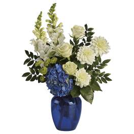 Blue and white floral arrangement in a cobalt vase