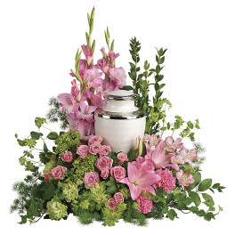 Pink floral funeral urn arrangement with lilies and roses