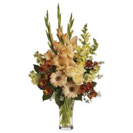 Peach and cream bouquet with roses and daisies in a clear glass vase