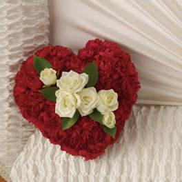 Heart-shaped bouquet of red and white roses with green leaves