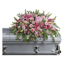 Pink floral spray on a silver casket