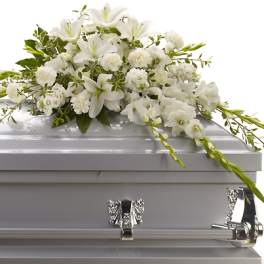 White floral spray on a silver casket