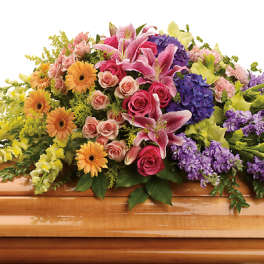 Colorful flower spray on a wooden casket