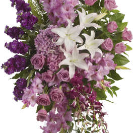 Tall purple and white floral standing spray on a white easel
